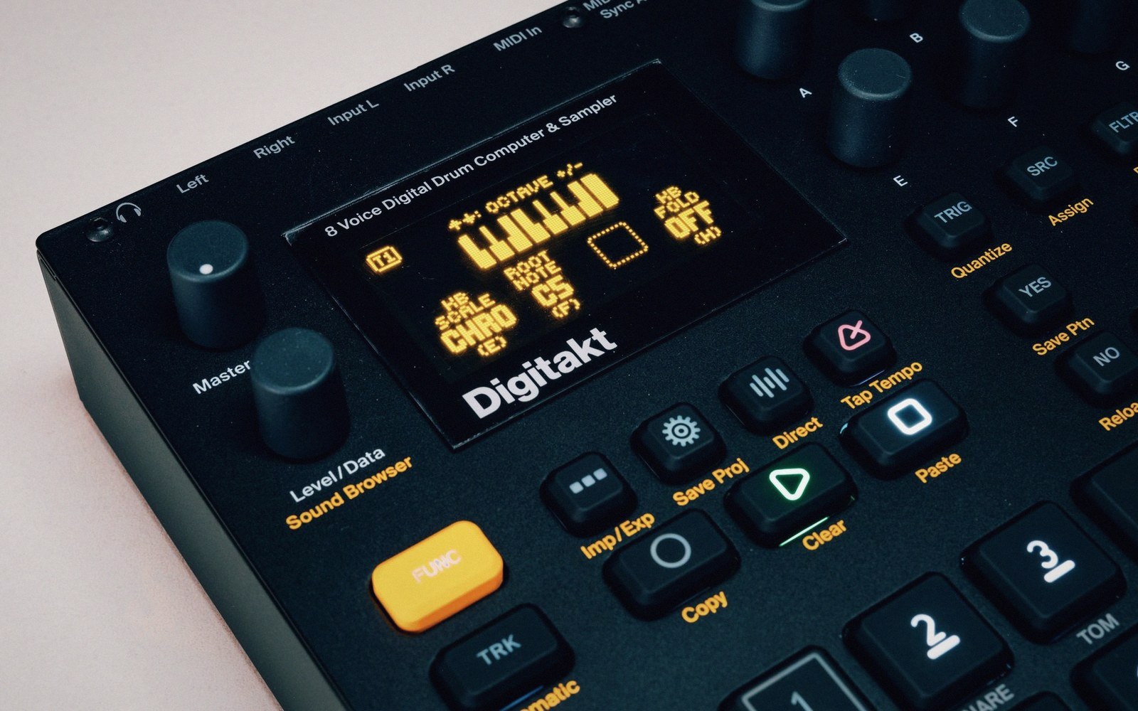 Close-up of a Digitakt drum computer showing its screen, knobs and buttons