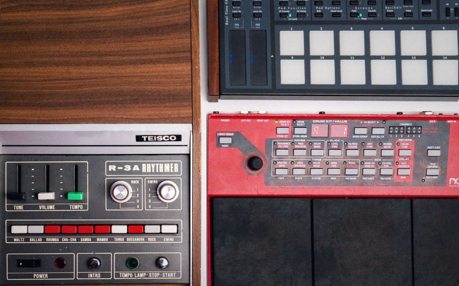 Vintage teisco r-3a rhythmer drum machine displayed beside modern red drum pad controllers